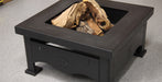 A square black metal fire pit table with a wood insert, shown on a gray carpeted floor.