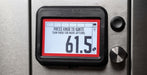 A close-up of a Black Earth digital fuel gauge display mounted on a brushed metal surface. The black bezel shows a white screen with a red border and large numbers reading 61.