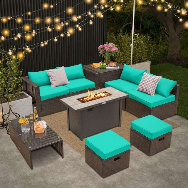 An outdoor patio furniture set featuring a fire pit table, coffee table, storage box, ottomans, corner sofas, and armless sofas with green cushions.